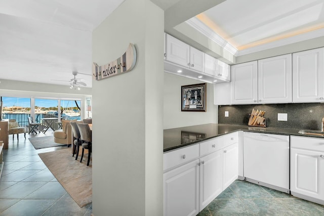 kitchen with dishwasher, white cabinets, backsplash, ceiling fan, and crown molding