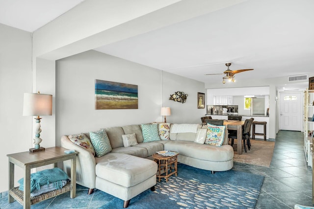 tiled living room featuring ceiling fan