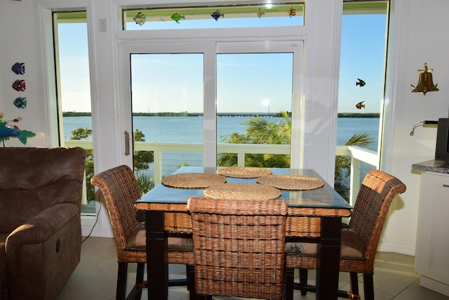 76 Palm Dr, Saddle Bunch, FL 33040 - dining space with light tile patterned floors, a water view, and plenty of natural light