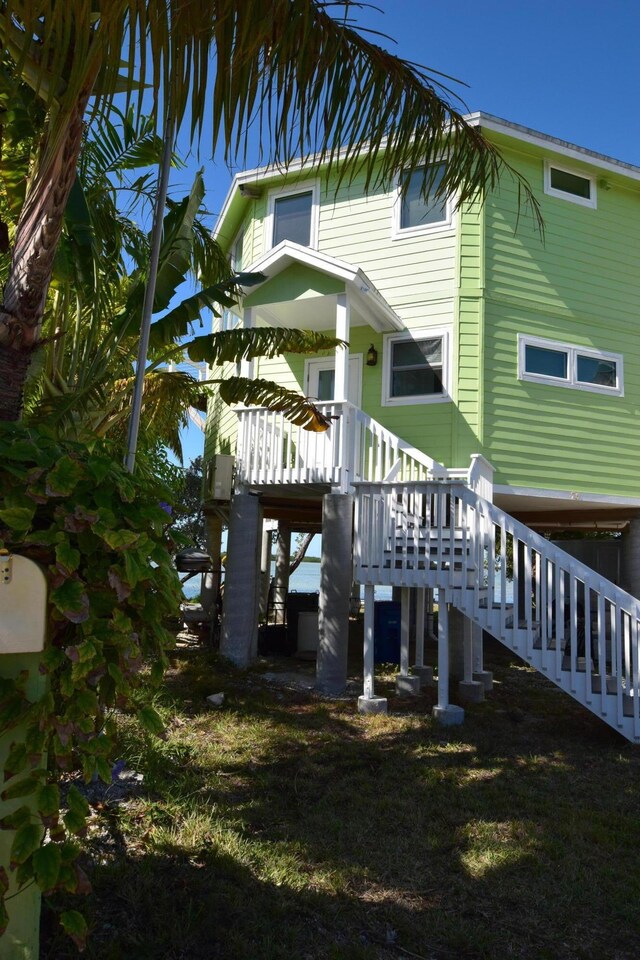 76 Palm Dr, Saddle Bunch, FL 33040 - rear view of property featuring a wooden deck and stairs