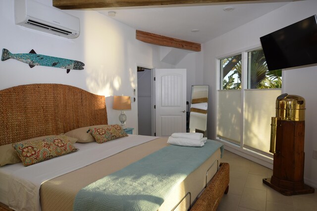 tiled bedroom with beamed ceiling and a wall mounted AC