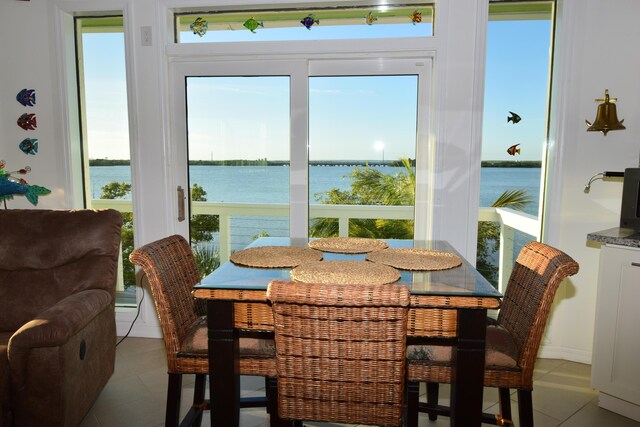 tiled dining area with a water view