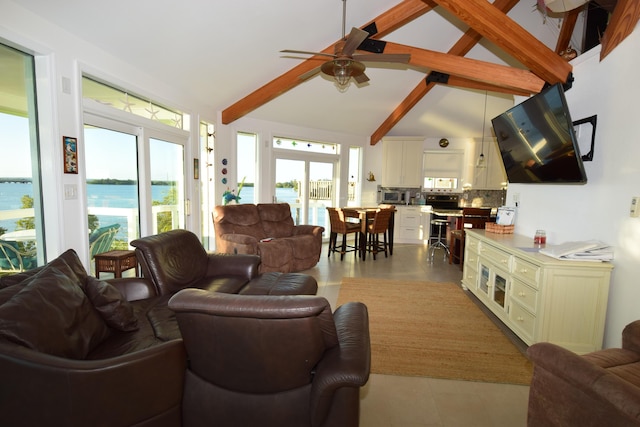 tiled living room featuring a water view, ceiling fan, and vaulted ceiling with beams