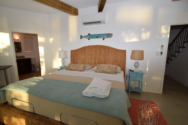 bedroom with beamed ceiling, a wall mounted air conditioner, and ensuite bath