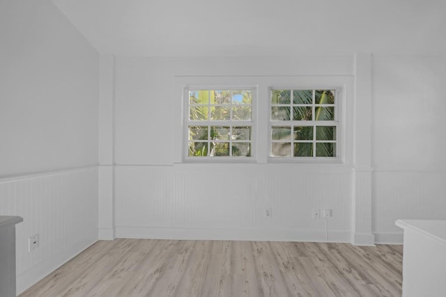 empty room with light hardwood / wood-style flooring