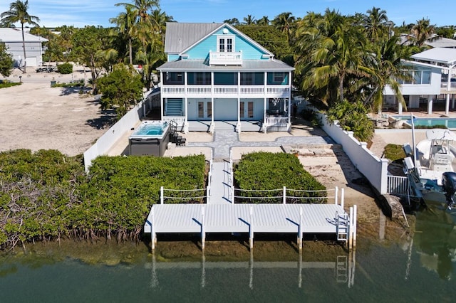 22562 Jolly Roger Dr, Cudjoe, FL 33042 - back of house with a water view, a balcony, a jacuzzi, and a patio area