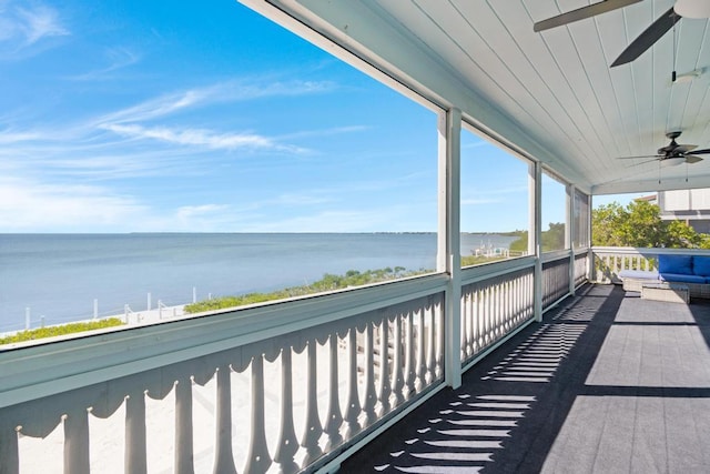 balcony with a water view and ceiling fan