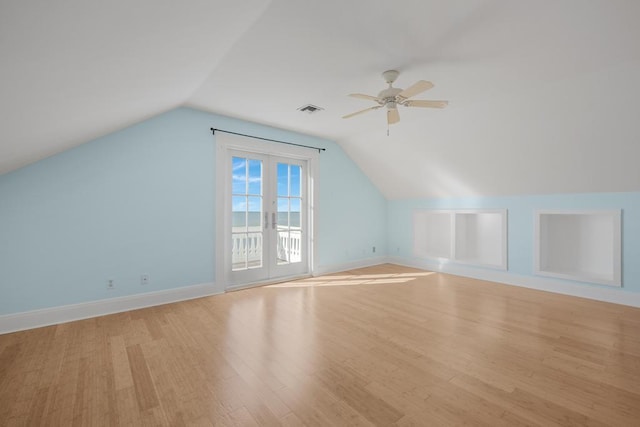 additional living space with light hardwood / wood-style flooring, ceiling fan, and vaulted ceiling