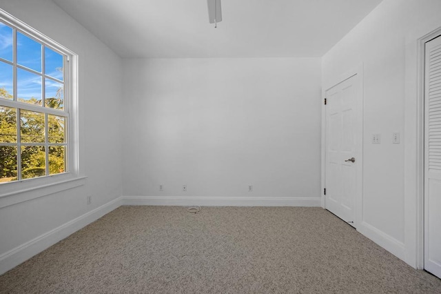 carpeted empty room with ceiling fan