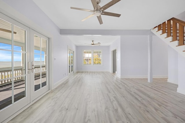 unfurnished living room with french doors, ceiling fan, and light hardwood / wood-style floors