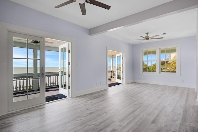 unfurnished room featuring beam ceiling, wood-type flooring, and ceiling fan