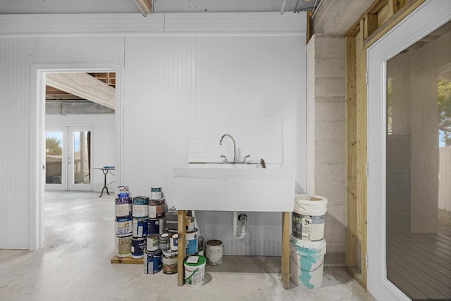 bathroom featuring sink, concrete floors, and french doors