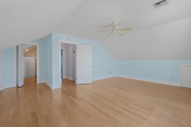 additional living space featuring lofted ceiling, light hardwood / wood-style flooring, and ceiling fan