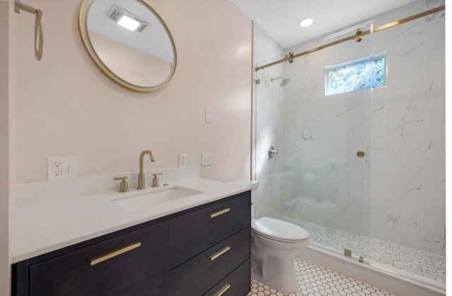 bathroom featuring vanity, an enclosed shower, and toilet