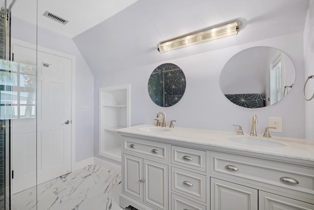 bathroom with lofted ceiling and vanity