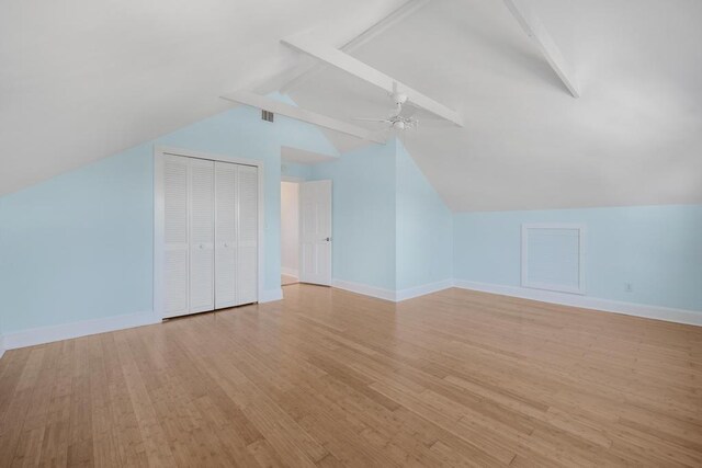 bonus room featuring vaulted ceiling with beams, light hardwood / wood-style floors, and ceiling fan