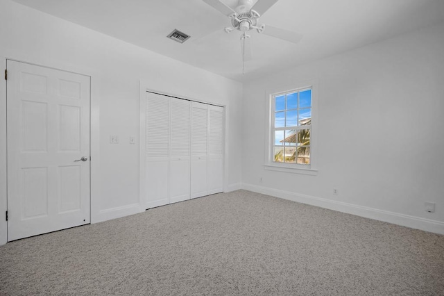 unfurnished bedroom featuring carpet floors, ceiling fan, and a closet