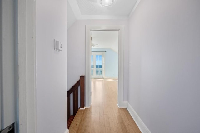 corridor with vaulted ceiling and light hardwood / wood-style floors