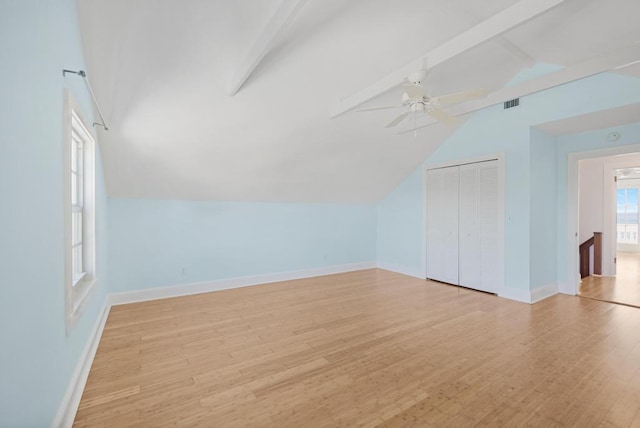 bonus room with lofted ceiling with beams, ceiling fan, and light wood-type flooring