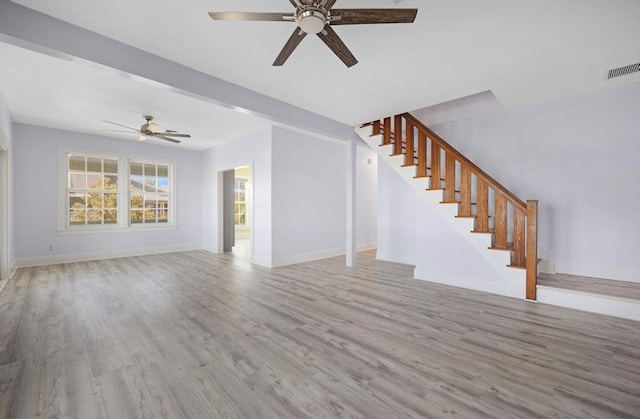 unfurnished living room featuring ceiling fan and light wood-type flooring