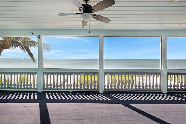 unfurnished sunroom featuring a water view and a healthy amount of sunlight