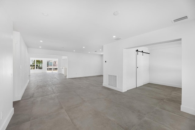 159 Iroquois Dr, Islamorada, FL 33036 - spare room featuring concrete floors, visible vents, baseboards, and a barn door