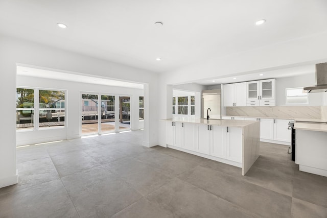 159 Iroquois Dr, Islamorada, FL 33036 - kitchen featuring wall chimney range hood, glass insert cabinets, white cabinets, and recessed lighting