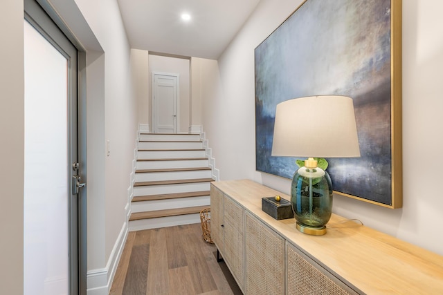 stairs with baseboards and wood finished floors