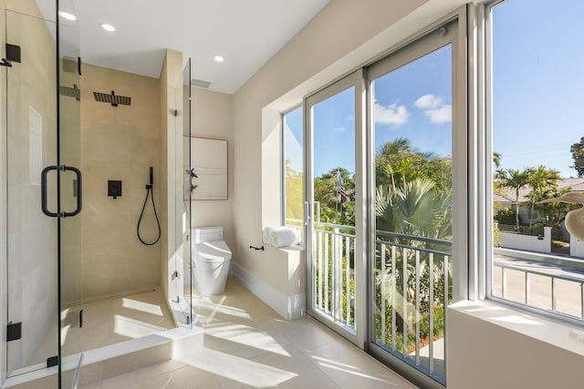 full bathroom featuring recessed lighting, toilet, a shower stall, baseboards, and tile patterned floors