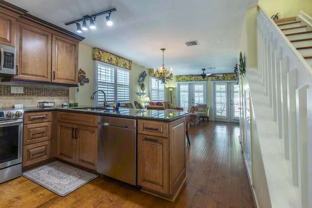 212 Southard St, Key West, FL 33040 - kitchen featuring stainless steel appliances, a sink, plenty of natural light, and a peninsula