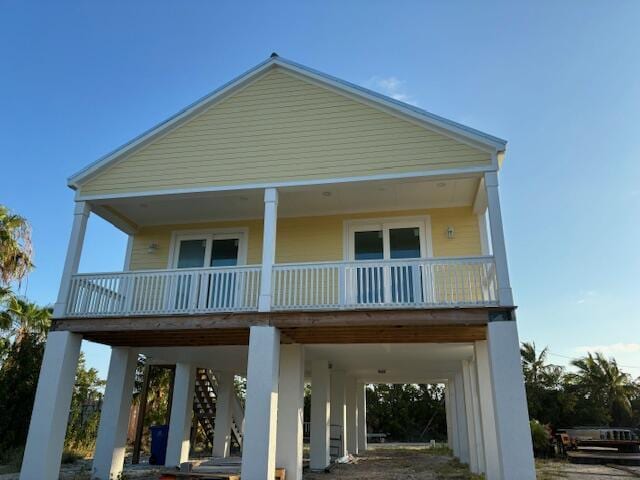 rear view of house with a carport and a porch