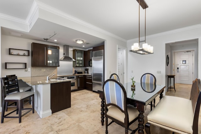 3841 N Roosevelt Blvd Unit 222, Key West, FL 33040 - kitchen with appliances with stainless steel finishes, tasteful backsplash, dark brown cabinetry, kitchen peninsula, and wall chimney exhaust hood