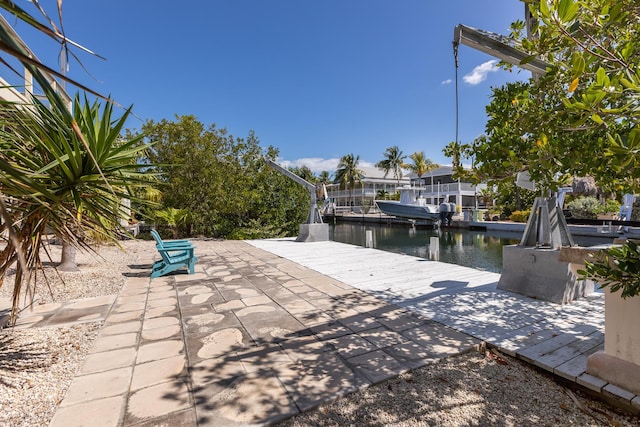 view of patio / terrace with a boat dock and a water view