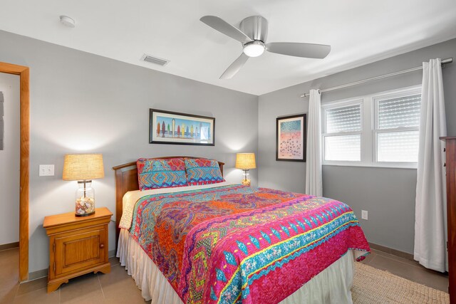 bedroom with light tile patterned floors and ceiling fan