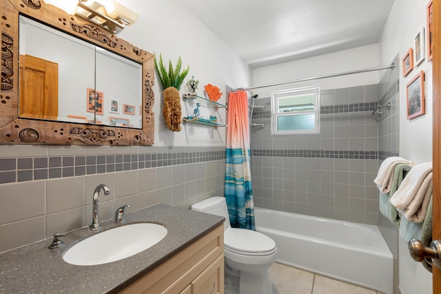 full bathroom with tile walls, tile patterned flooring, vanity, toilet, and shower / bath combo