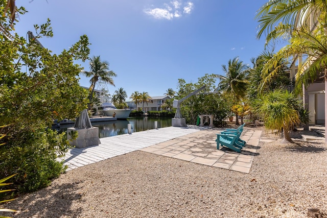 view of dock featuring a water view and a patio