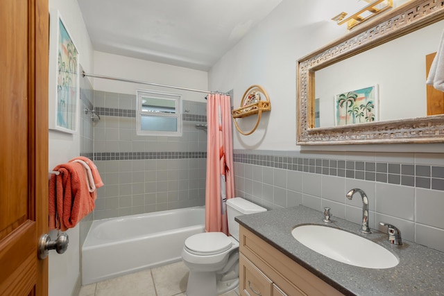 full bathroom with tile walls, tile patterned flooring, vanity, shower / tub combo, and toilet