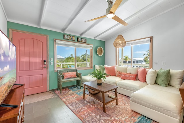 living room featuring ceiling fan, a healthy amount of sunlight, and lofted ceiling with beams