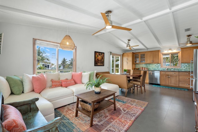 living room featuring vaulted ceiling with beams, sink, and ceiling fan