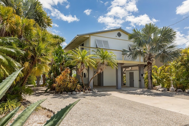 raised beach house featuring a carport