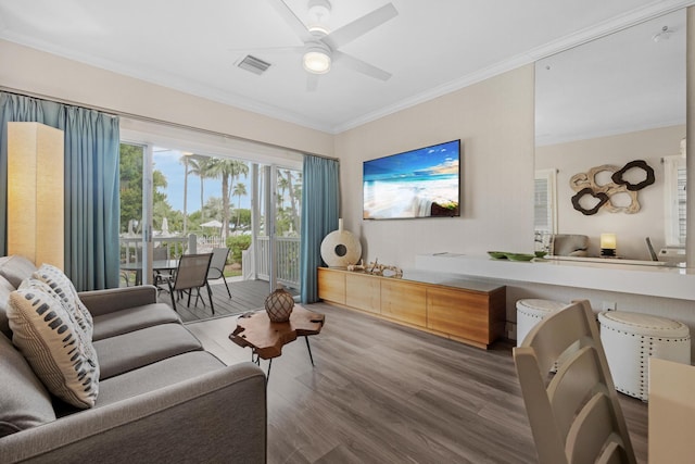 living room featuring ceiling fan, ornamental molding, and hardwood / wood-style floors