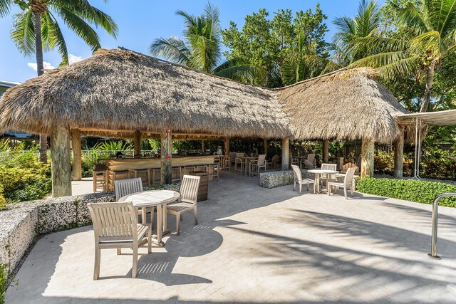 view of patio featuring a bar and a gazebo