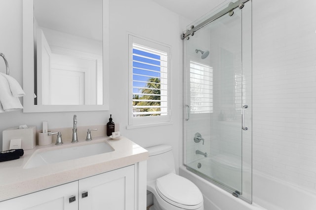 full bathroom featuring toilet, vanity, and bath / shower combo with glass door