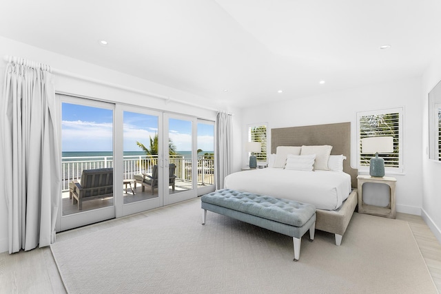 bedroom with a water view, access to exterior, and french doors