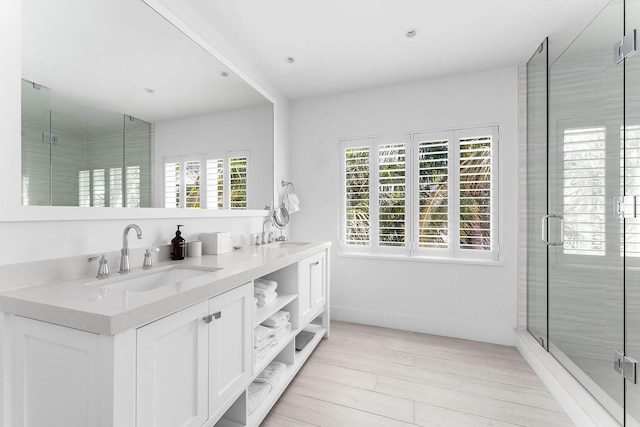 bathroom featuring vanity, hardwood / wood-style flooring, and walk in shower