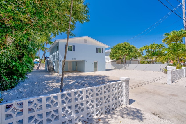 back of house with a patio area, stairway, stucco siding, and fence private yard