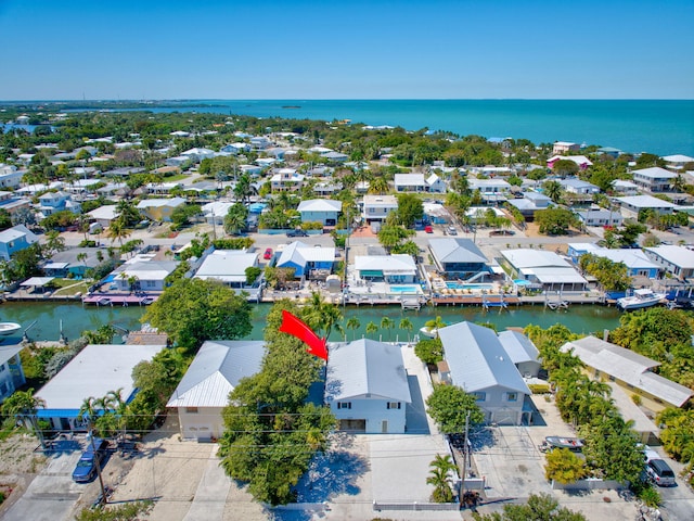 drone / aerial view featuring a residential view and a water view