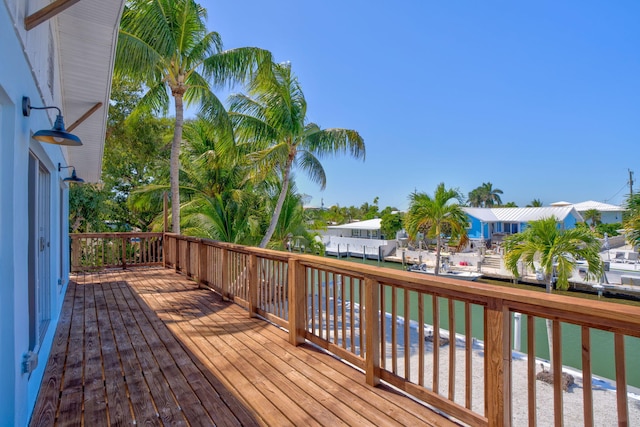 wooden deck with a residential view and a water view