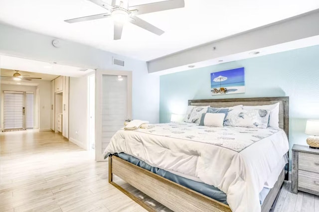 bedroom with ceiling fan and light wood-type flooring