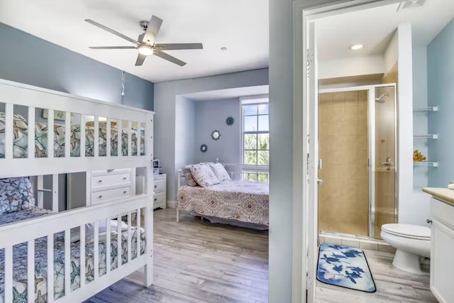 bedroom featuring ceiling fan, connected bathroom, and light wood-type flooring